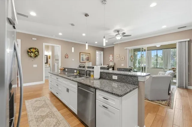 a kitchen with granite countertop a sink and a counter top space
