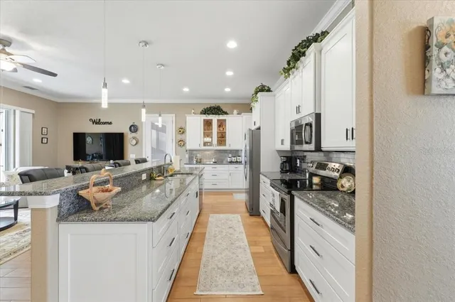a dining room with furniture a flat screen tv and a large window