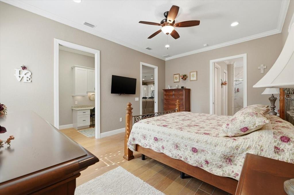 708 Teaberry Trail Polk City, FL 33868 - Photo 27 of 46 a bedroom with a bed and a flat tv screen on dresser