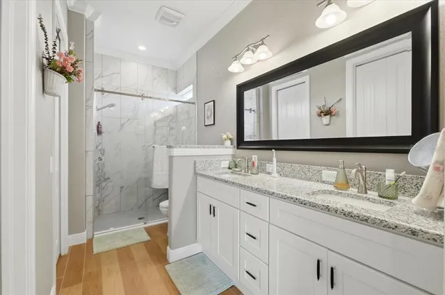 a white toilet sitting next to a bathroom shower