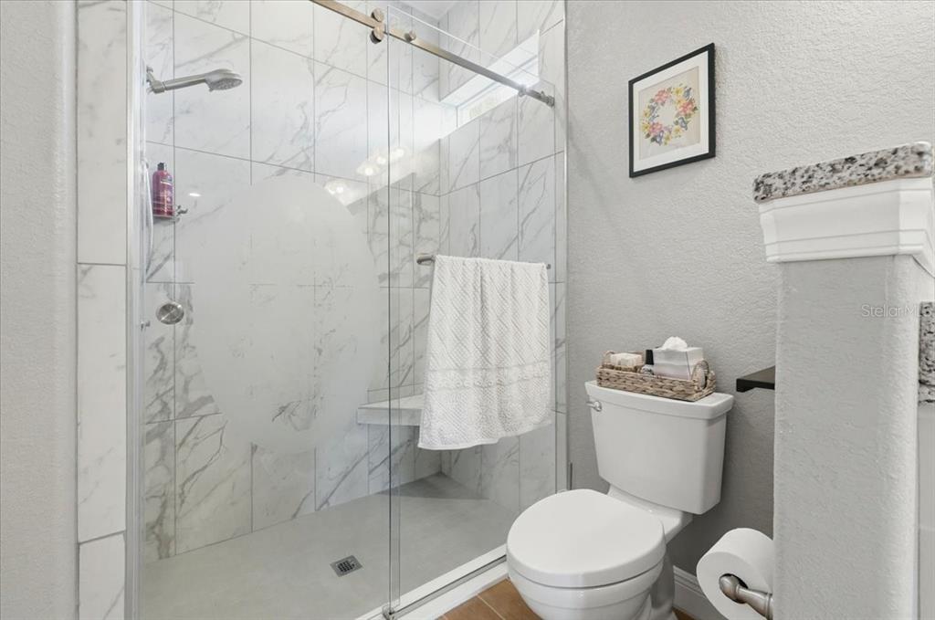 708 Teaberry Trail Polk City, FL 33868 - Photo 31 of 46 a white toilet sitting next to a bathroom shower