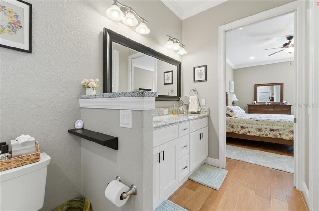 708 Teaberry Trail Polk City, FL 33868 - Photo 32 of 46 a en suite bathroom with a double vanity sink and a mirror