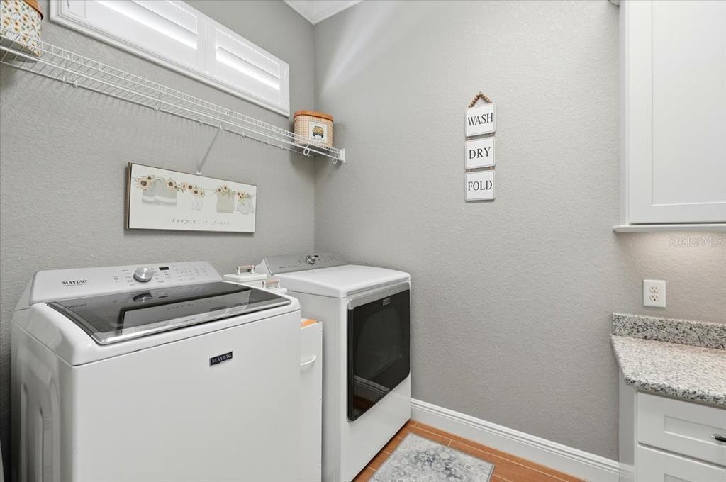 708 Teaberry Trail Polk City, FL 33868 - Photo 34 of 46 a utility room with dryer and washer