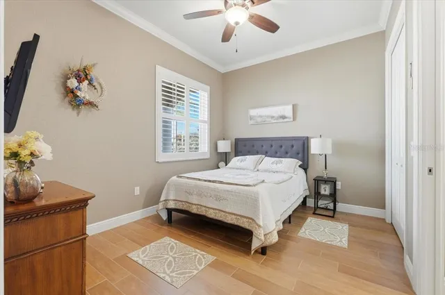 a spacious bedroom with a bed and a chandelier