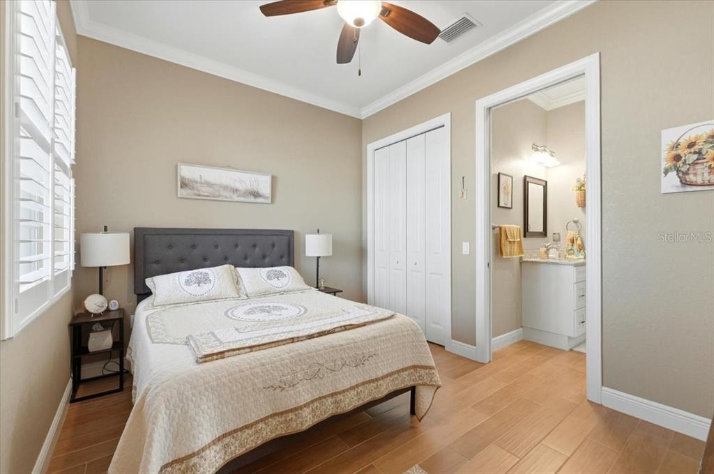 708 Teaberry Trail Polk City, FL 33868 - Photo 38 of 46 a spacious bedroom with a bed and a chandelier