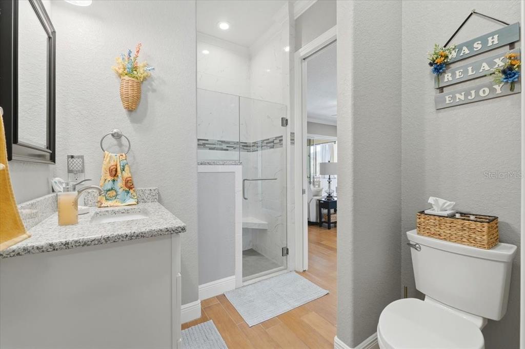 708 Teaberry Trail Polk City, FL 33868 - Photo 39 of 46 a bathroom with a granite countertop sink mirror and toilet