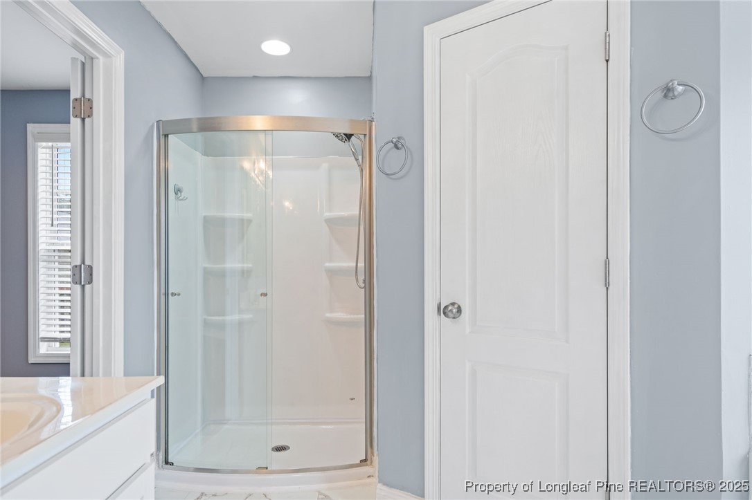 4225 Redmill Lane Hope Mills, NC 28348 - Photo 20 of 40 a bathroom with a glass shower door