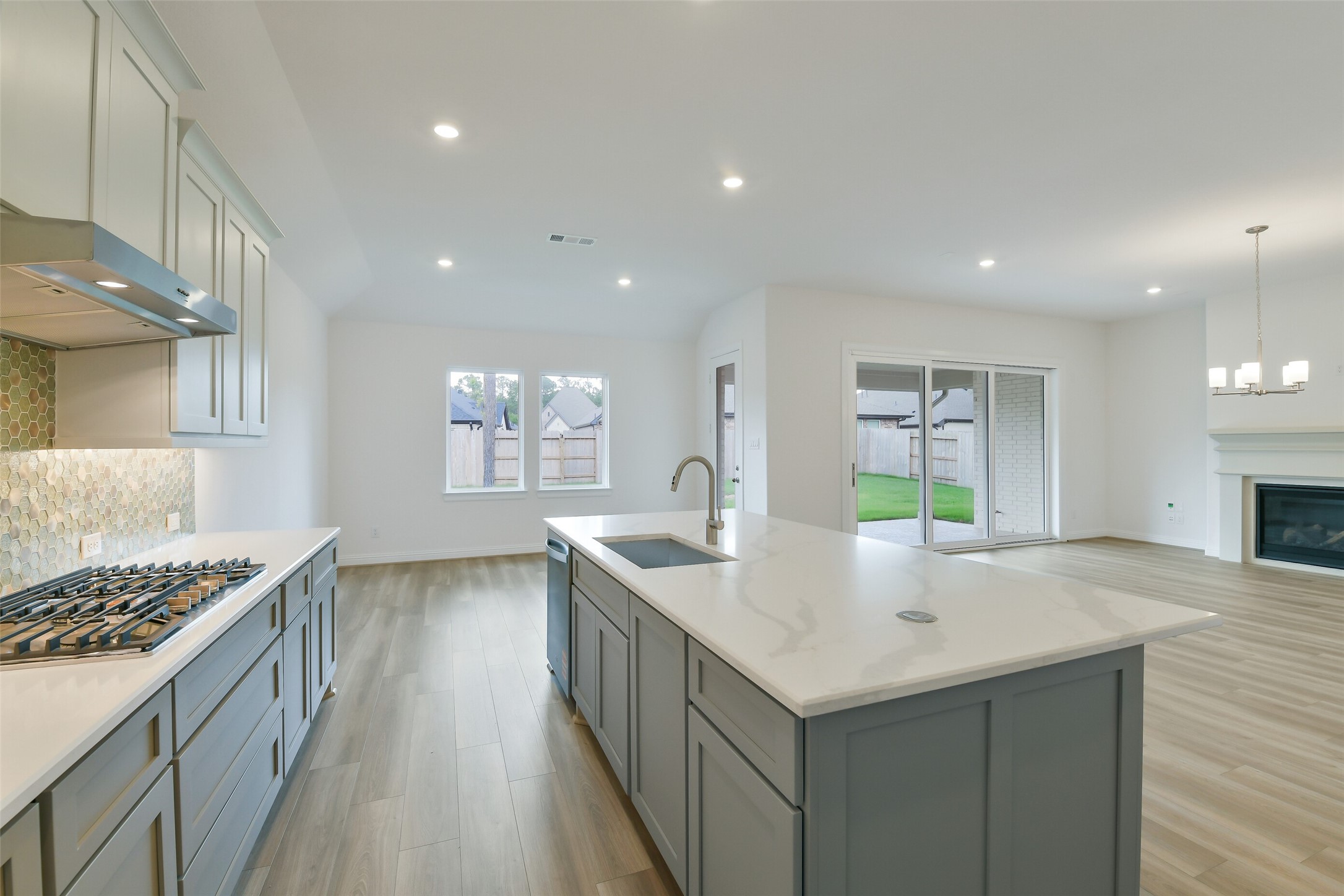 16119 Rustling Wds Road Conroe, TX 77302 - Photo 12 of 43 a kitchen with stainless steel appliances granite countertop a sink stove and cabinets