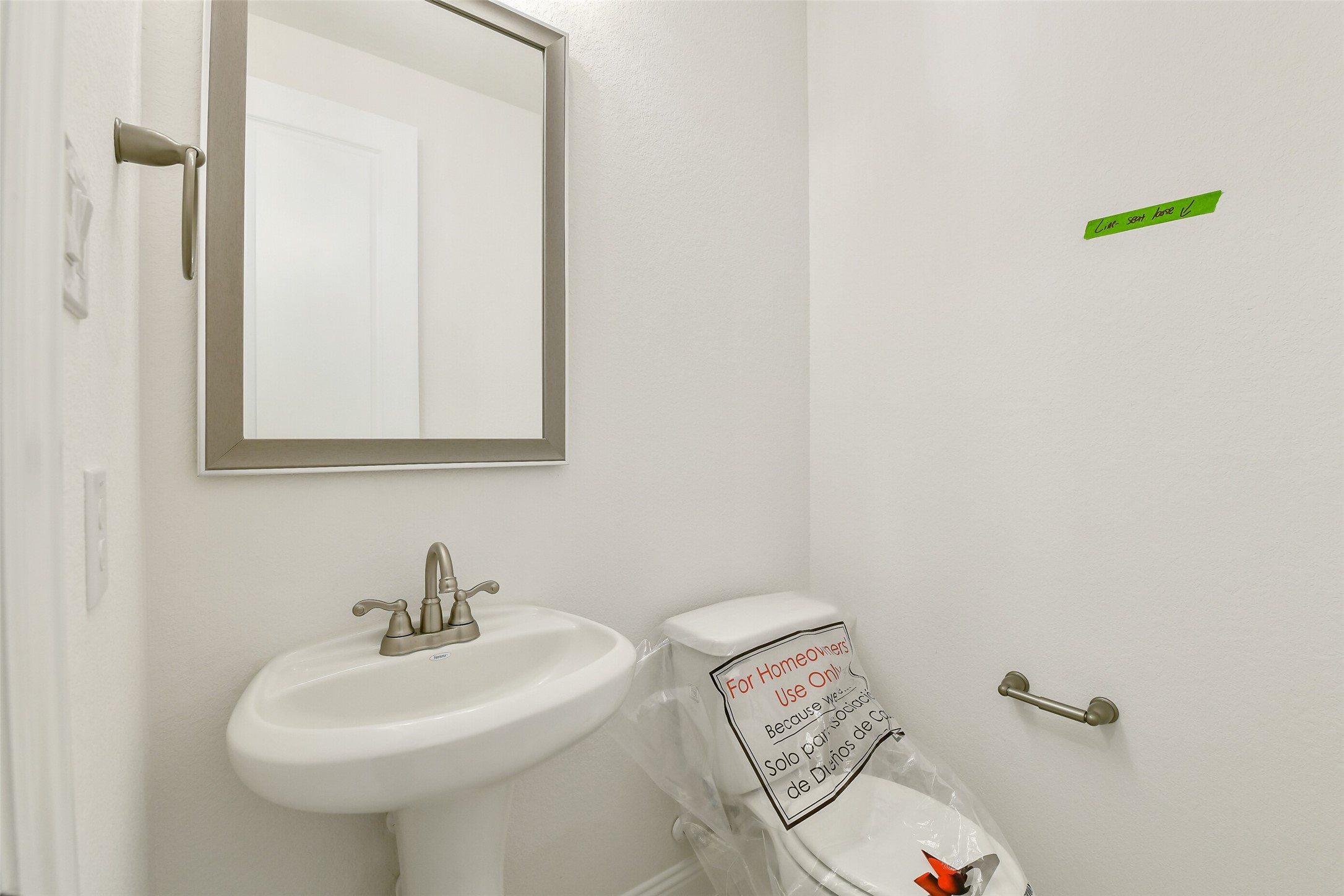 16119 Rustling Wds Road Conroe, TX 77302 - Photo 18 of 43 a bathroom with a sink a toilet and mirror