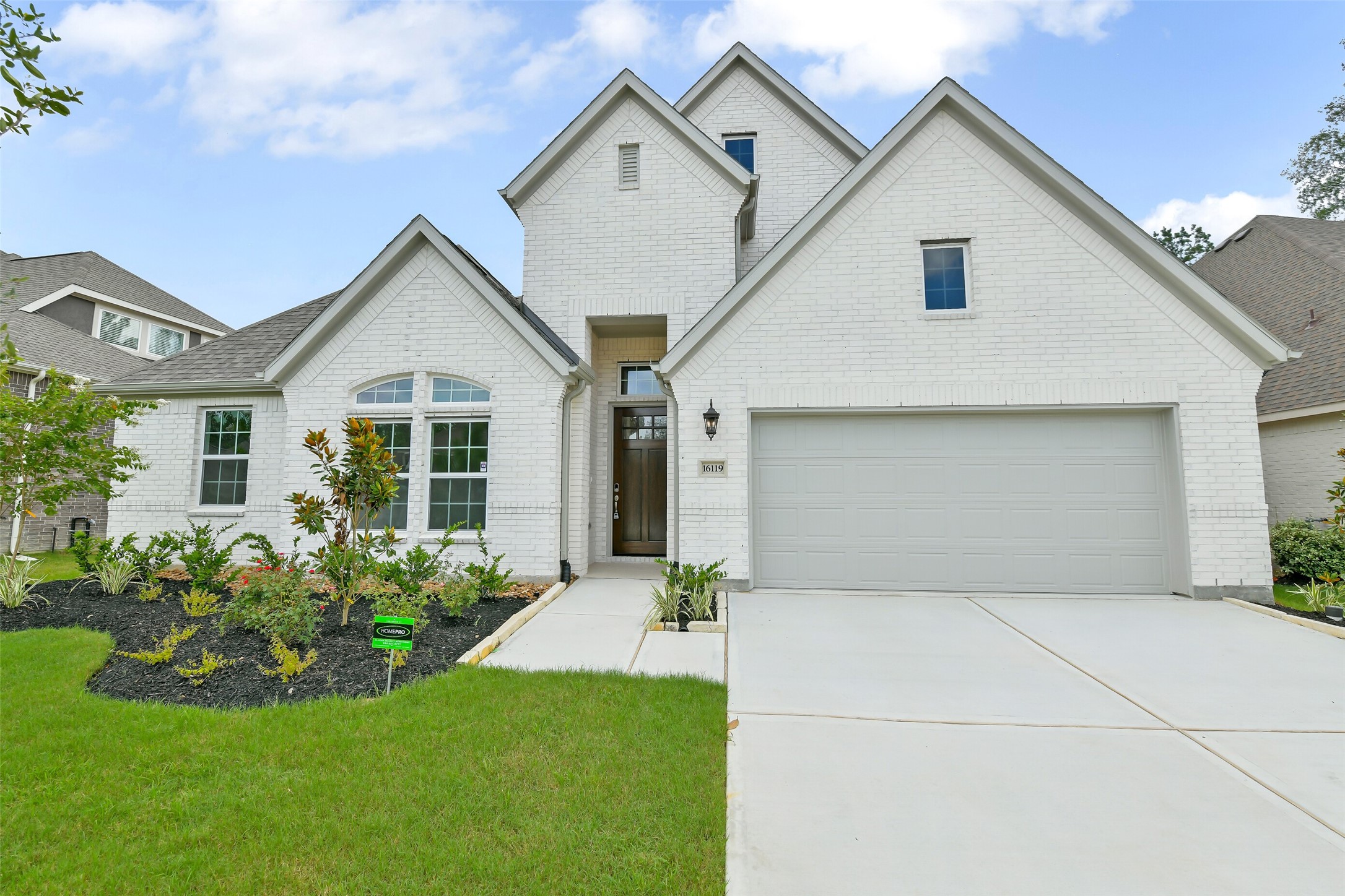 16119 Rustling Wds Road Conroe, TX 77302 - Photo 2 of 43 a front view of a house with a yard and garage