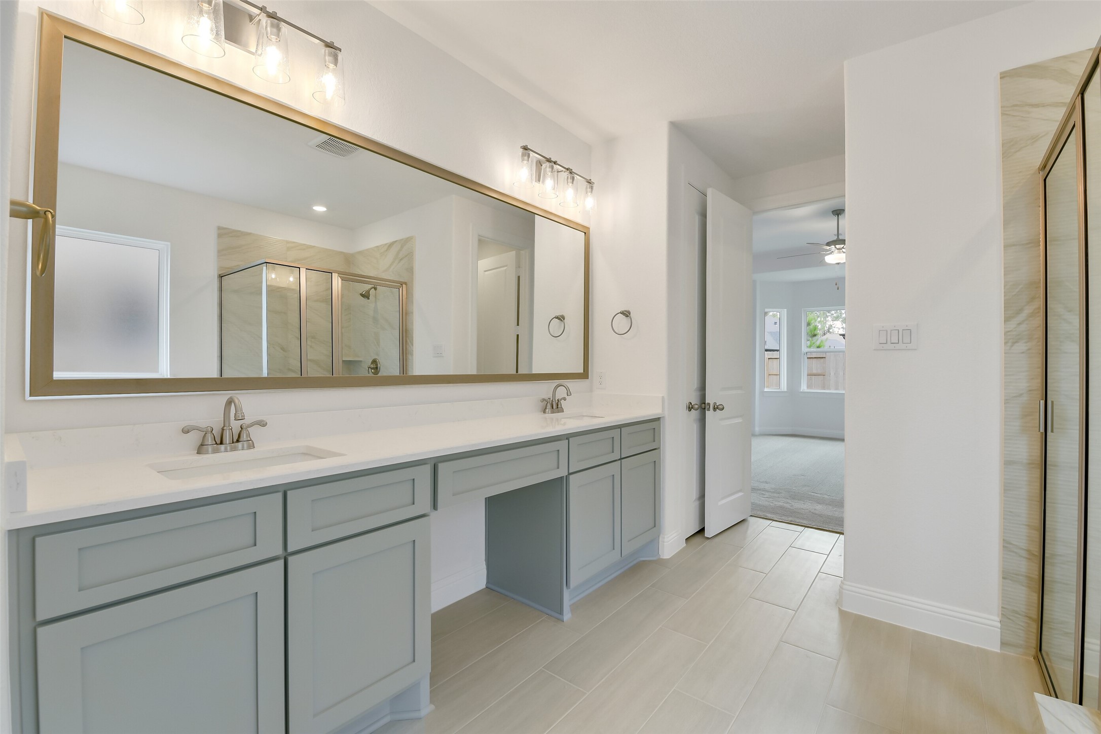 16119 Rustling Wds Road Conroe, TX 77302 - Photo 22 of 43 a spacious bathroom with a double vanity sink mirror and shower