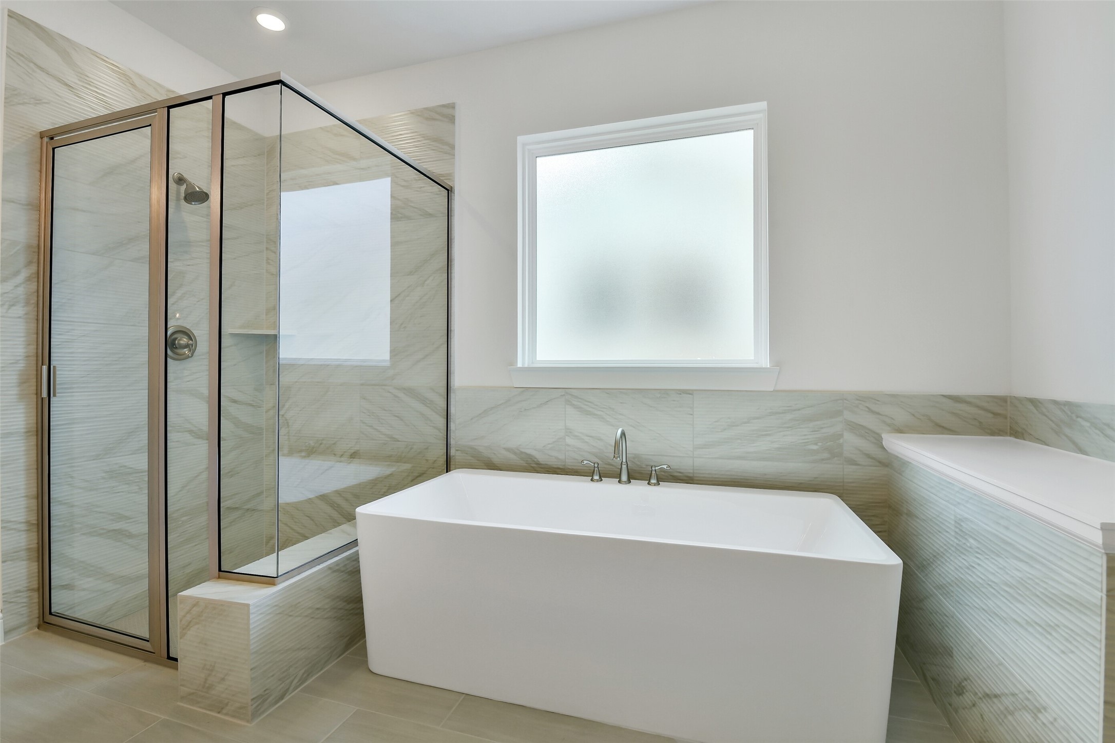 16119 Rustling Wds Road Conroe, TX 77302 - Photo 23 of 43 a bathroom with a tub a sink and glass door