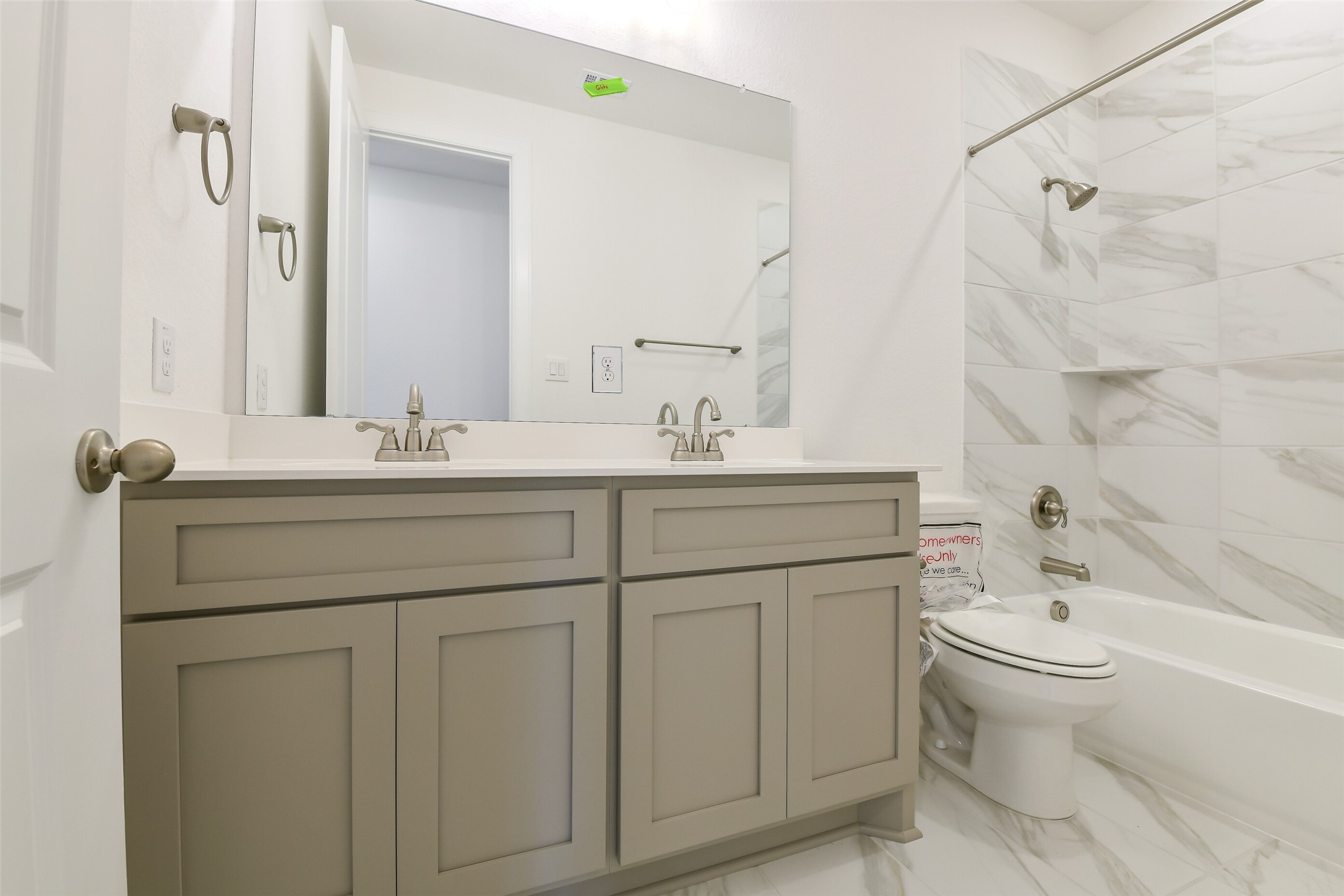 16119 Rustling Wds Road Conroe, TX 77302 - Photo 32 of 43 a bathroom with a double vanity sink toilet and shower