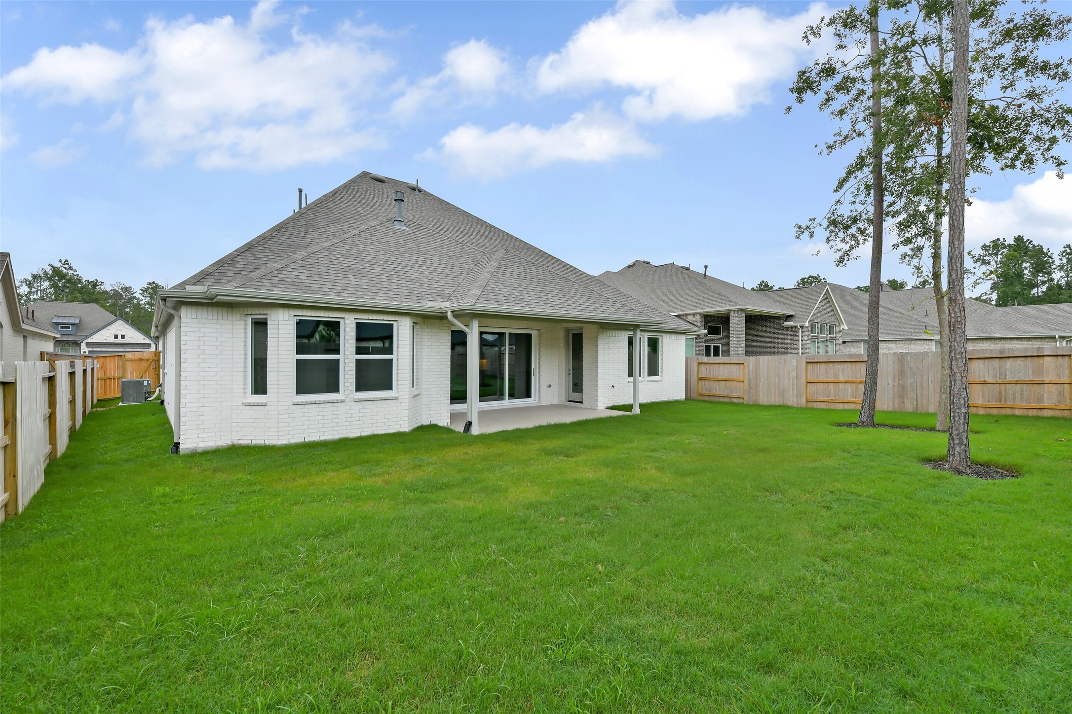16119 Rustling Wds Road Conroe, TX 77302 - Photo 36 of 43 a backyard of a house with plants and large tree