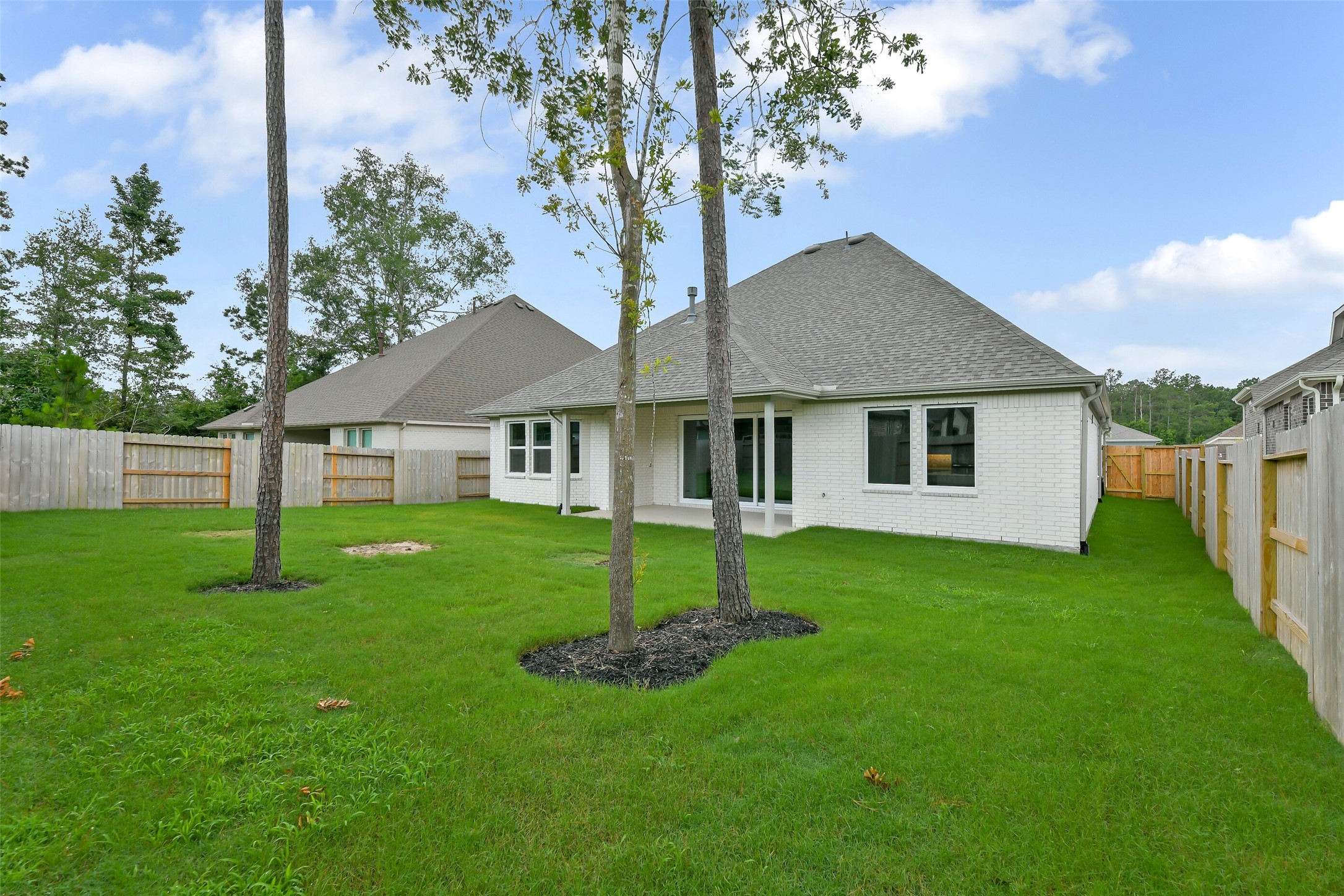 16119 Rustling Wds Road Conroe, TX 77302 - Photo 37 of 43 a house that is sitting in the grass