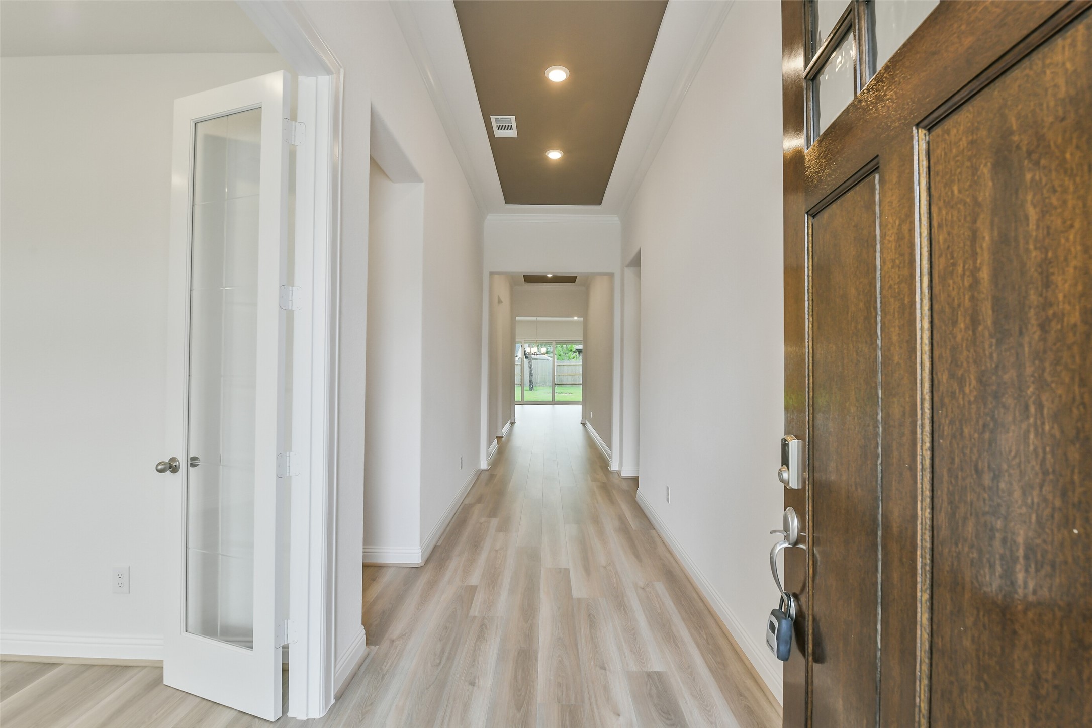 16119 Rustling Wds Road Conroe, TX 77302 - Photo 4 of 43 a view of a hallway with wooden floor and staircase