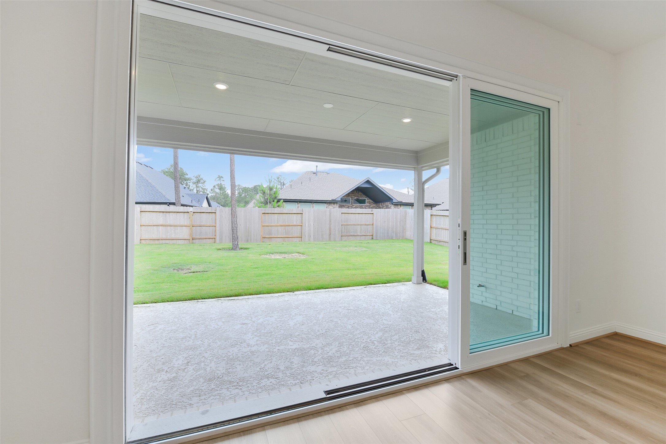 16119 Rustling Wds Road Conroe, TX 77302 - Photo 7 of 43 a view of a room with wooden floor and a porch