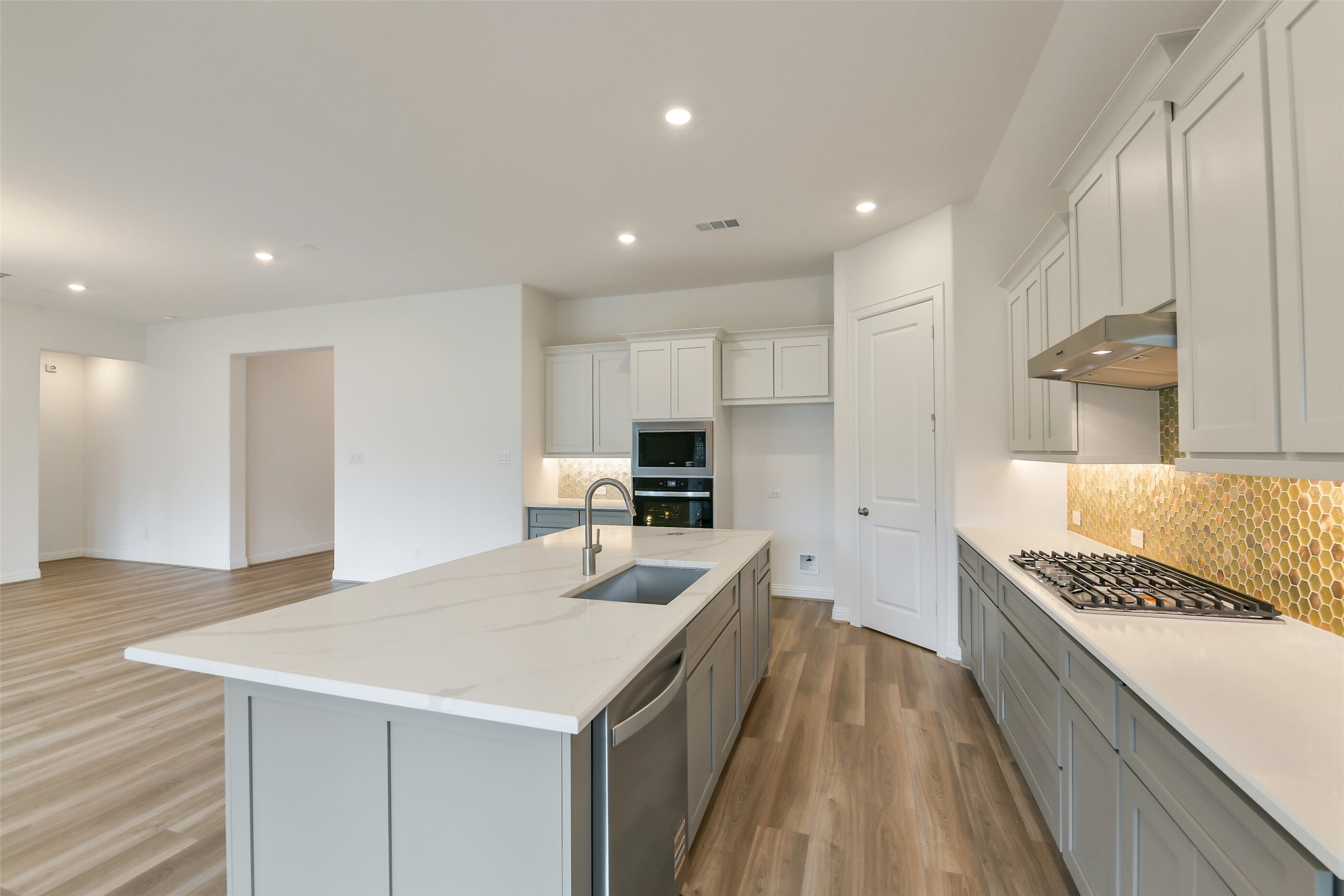 16119 Rustling Wds Road Conroe, TX 77302 - Photo 10 of 43 a kitchen with a sink a counter top space and appliances