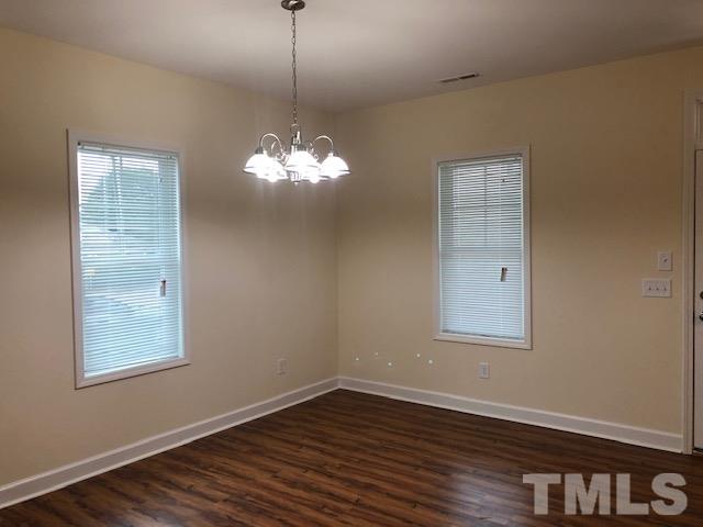 520 Branch Street Raleigh, NC 27601 - Photo 3 of 13 a view of a room with wooden floor chandelier and window