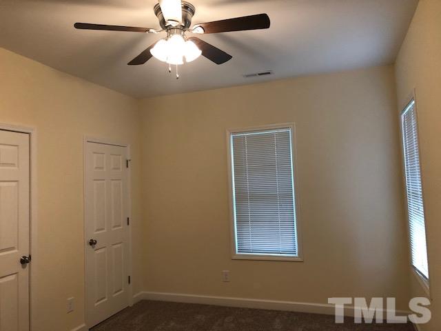 520 Branch Street Raleigh, NC 27601 - Photo 9 of 13 a view of an empty room with a window and a chandelier fan