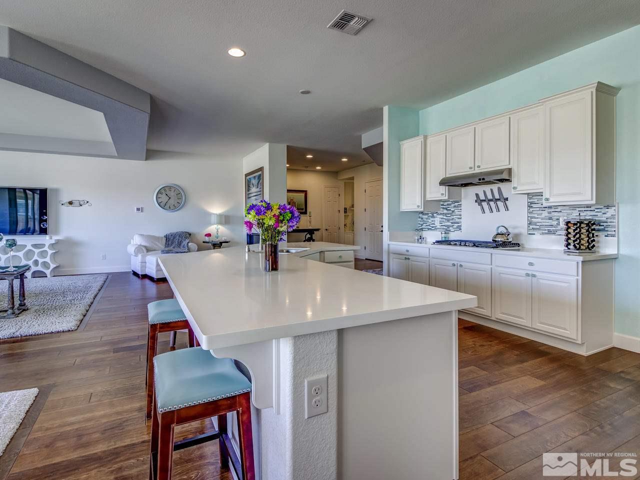 2020 Blue Boy Lane Reno, NV 89521 - Photo 7 of 20 a kitchen with stainless steel appliances granite countertop a table chairs sink and cabinets