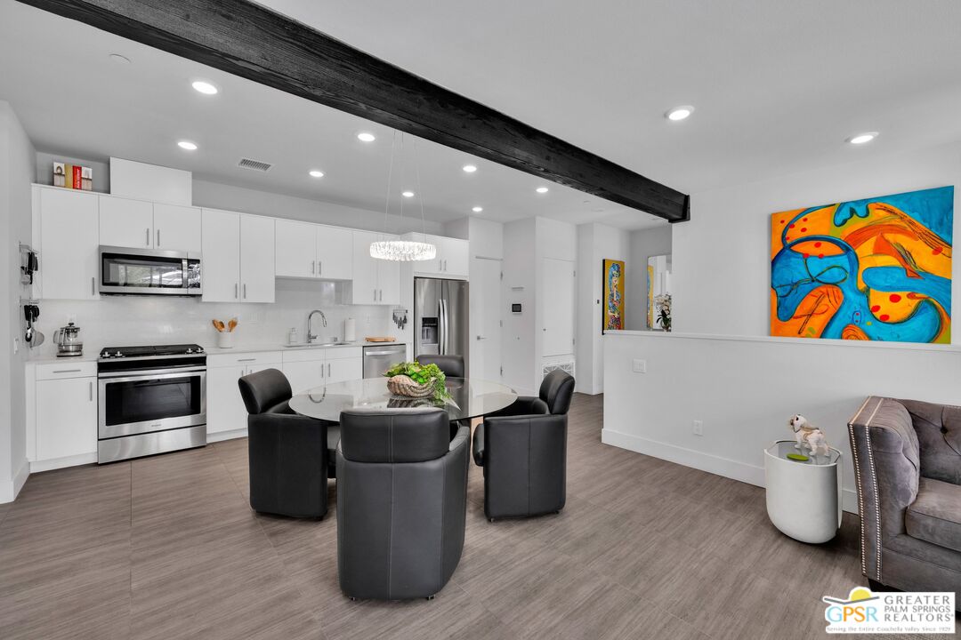 138 The River Palm Springs, CA 92262 - Photo 12 of 47 a kitchen with stainless steel appliances granite countertop a sink and a microwave