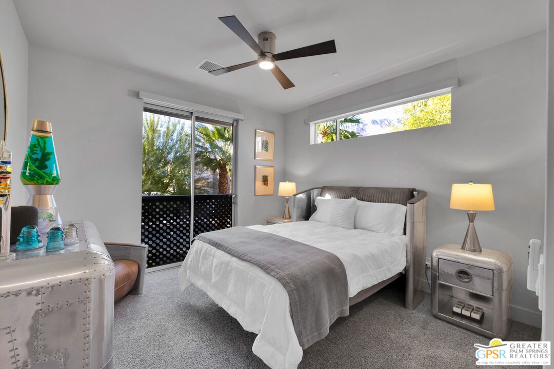 138 The River Palm Springs, CA 92262 - Photo 22 of 47 a bedroom with a bed and a chandelier