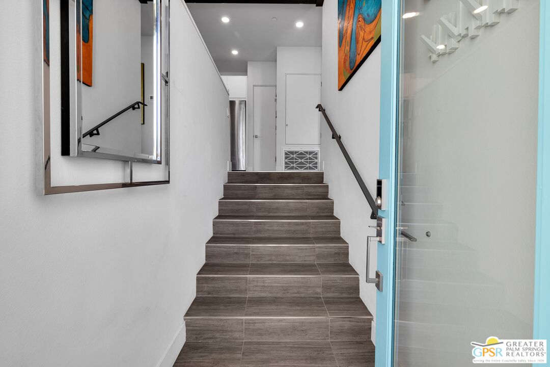 138 The River Palm Springs, CA 92262 - Photo 3 of 47 a view of staircase with wooden floor and a chandelier