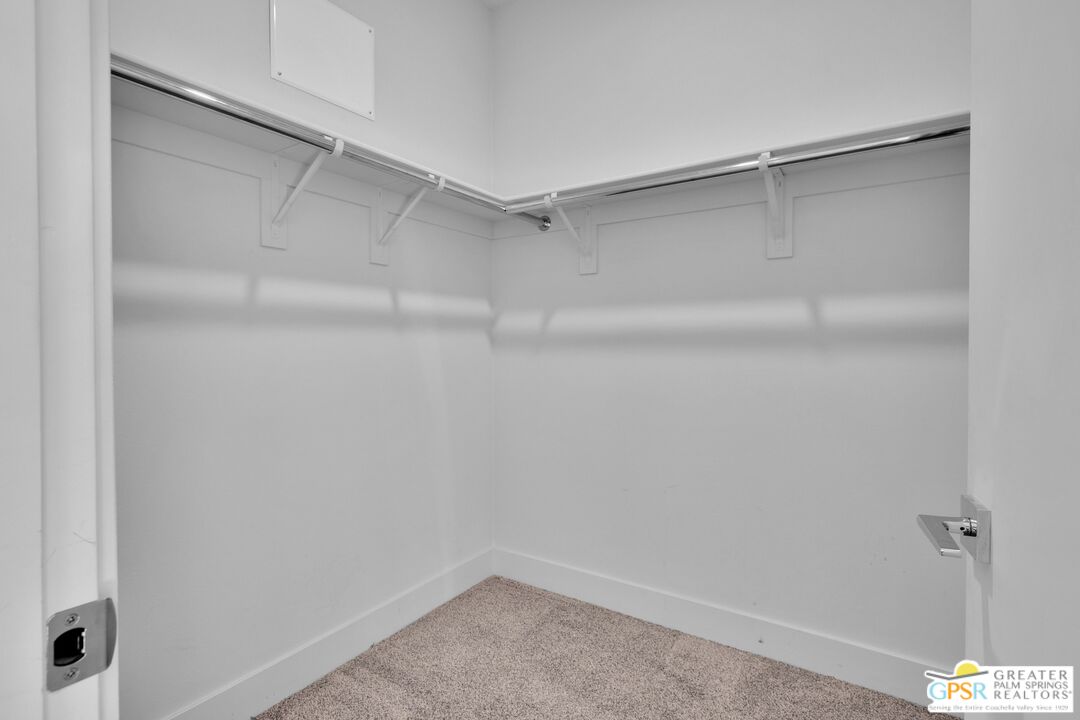 138 The River Palm Springs, CA 92262 - Photo 31 of 47 a view of a room with racks on the wall