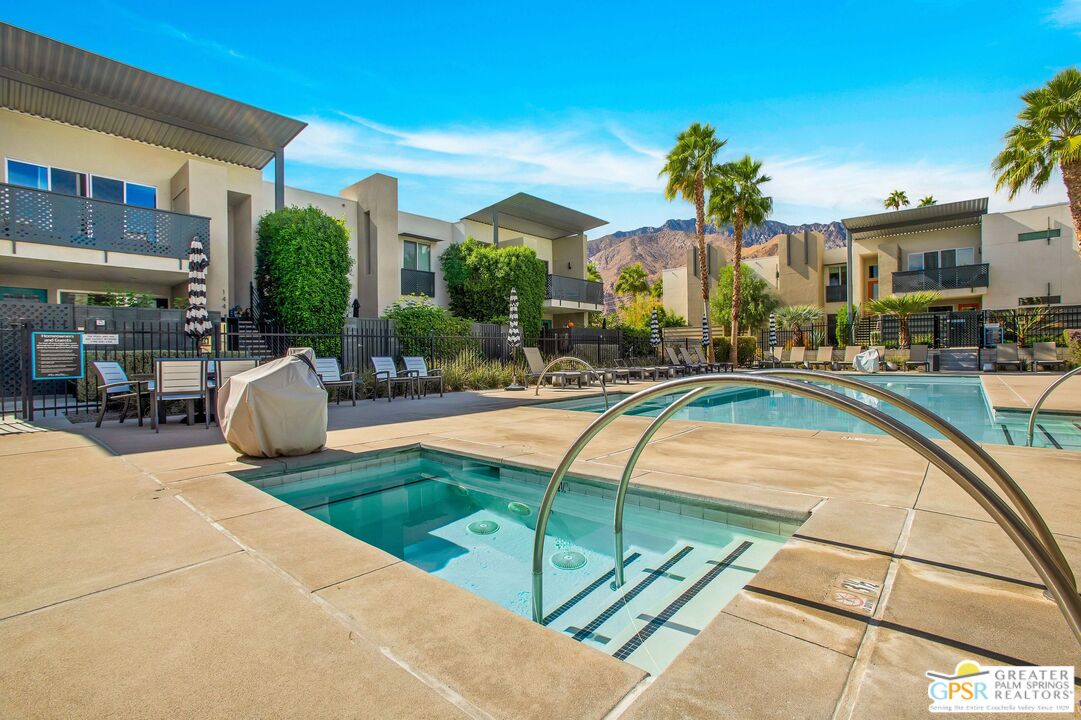 138 The River Palm Springs, CA 92262 - Photo 40 of 47 a view of a swimming pool with outdoor seating and a patio