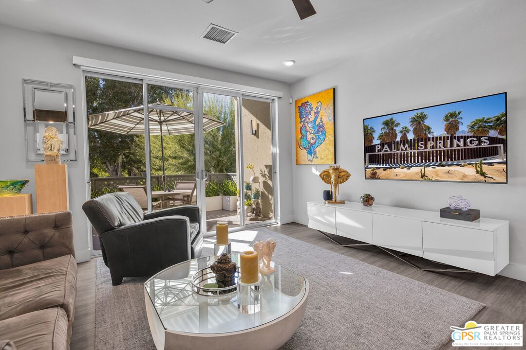 138 The River Palm Springs, CA 92262 - Photo 5 of 47 a living room with furniture and a large window