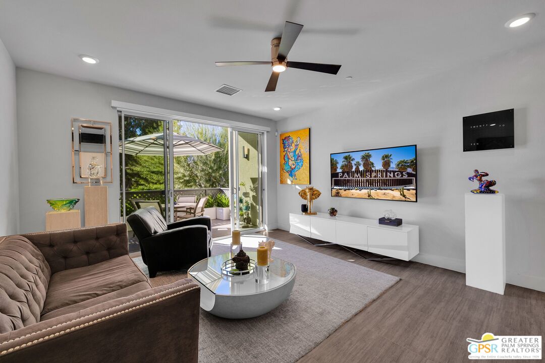 138 The River Palm Springs, CA 92262 - Photo 9 of 47 a living room with furniture and a flat screen tv