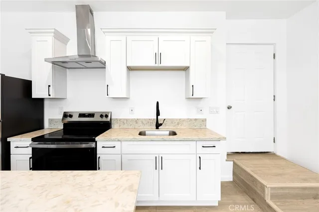 a kitchen with kitchen island granite countertop a sink stainless steel appliances and cabinets
