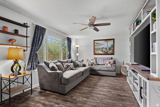 7659 State Street Midvale, UT 84047 - Photo 4 of 33 Spacious living area featuring wood-finish flooring, a large window, and a ceiling fan