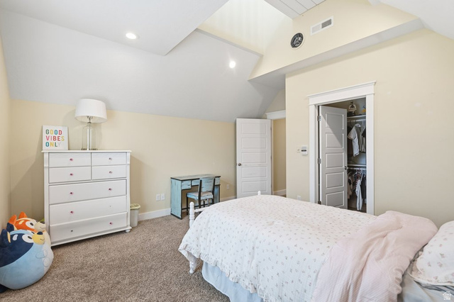 672 Perry Hollow Drive Mapleton, UT 84664 - Photo 53 of 106 Bedroom featuring vaulted ceilings with recessed lighting, neutral wall tones, textured carpet flooring, an open closet with built-in shelving, and a paneled interior door