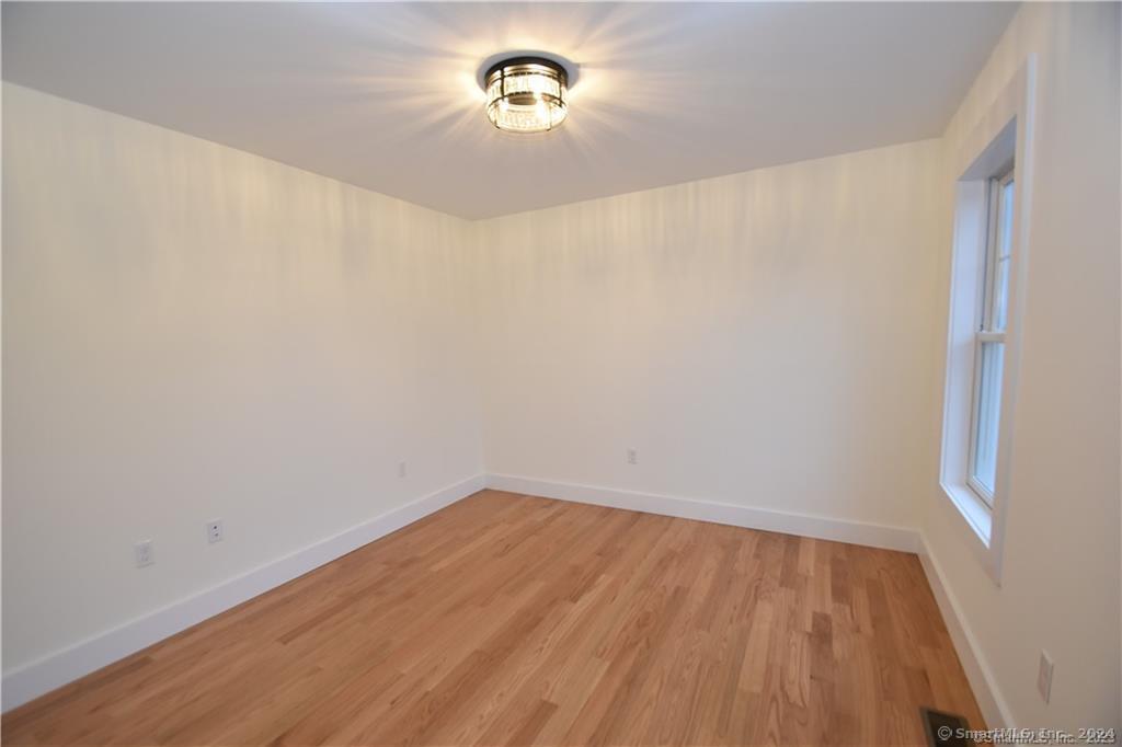 Mile Hill Road Tolland, CT 06084 - Photo 15 of 32 a view of a room with wooden floor and a window