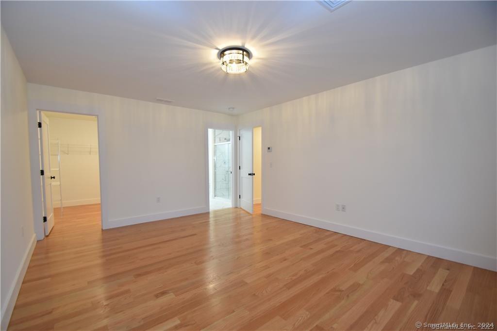 Mile Hill Road Tolland, CT 06084 - Photo 20 of 32 a view of an empty room with wooden floor