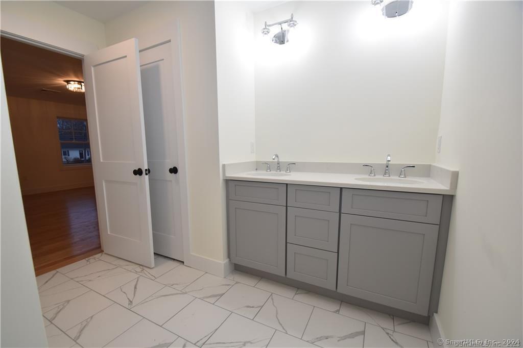 Mile Hill Road Tolland, CT 06084 - Photo 22 of 32 a bathroom with a sink and a mirror