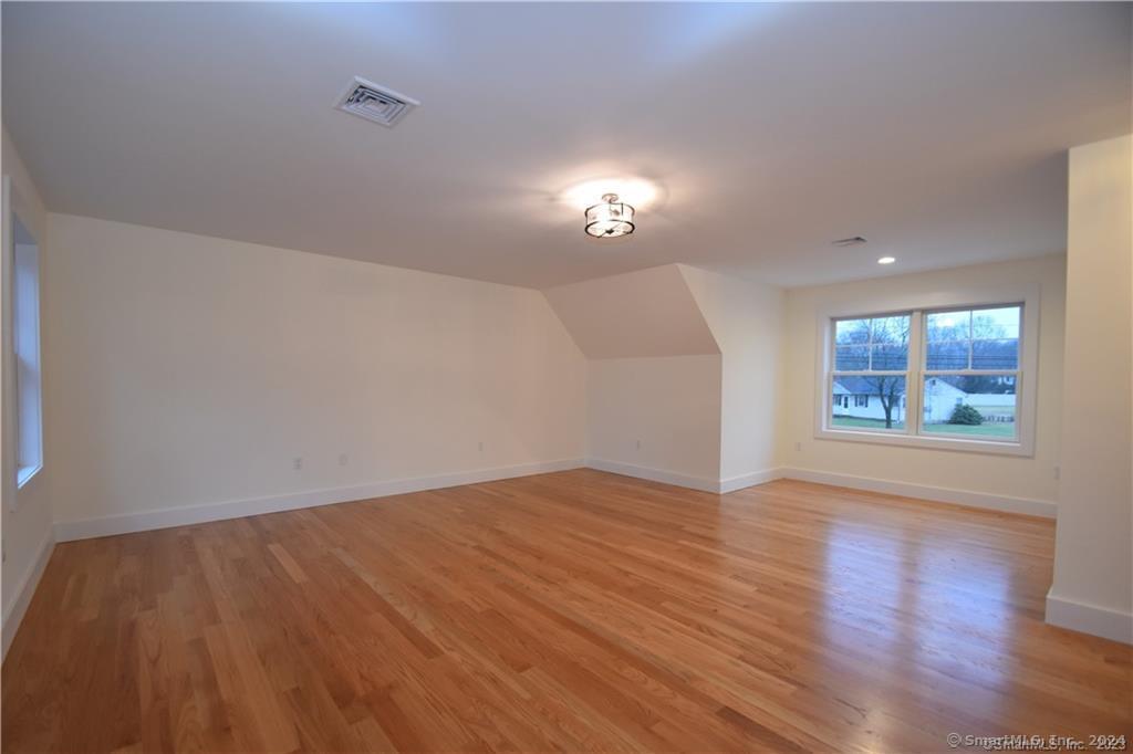 Mile Hill Road Tolland, CT 06084 - Photo 29 of 32 an empty room with wooden floor and windows