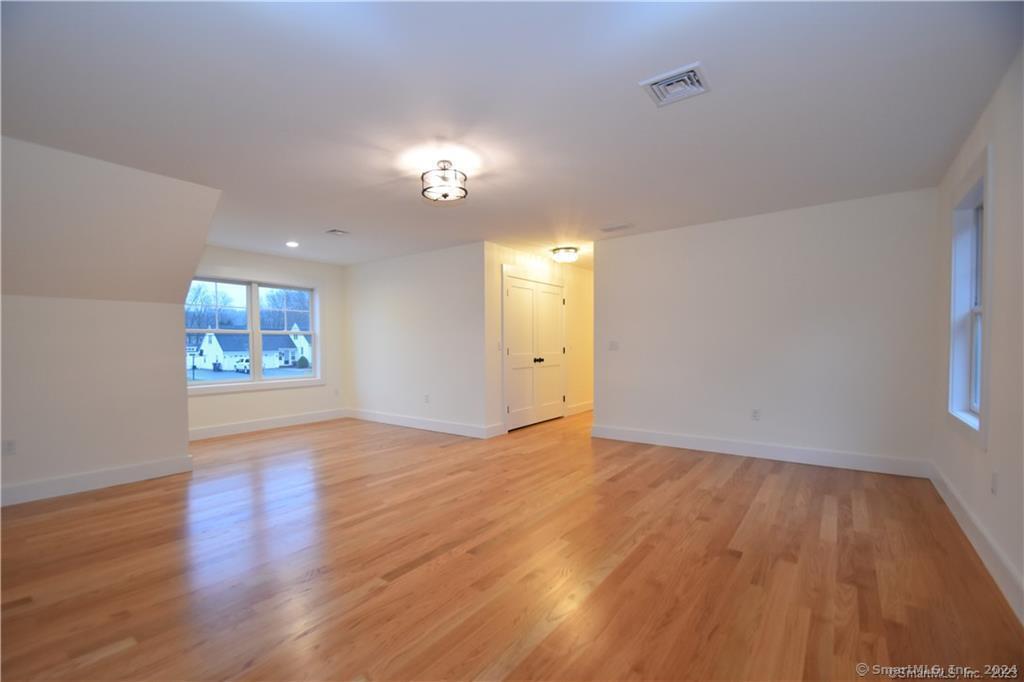 Mile Hill Road Tolland, CT 06084 - Photo 30 of 32 an empty room with wooden floor and windows