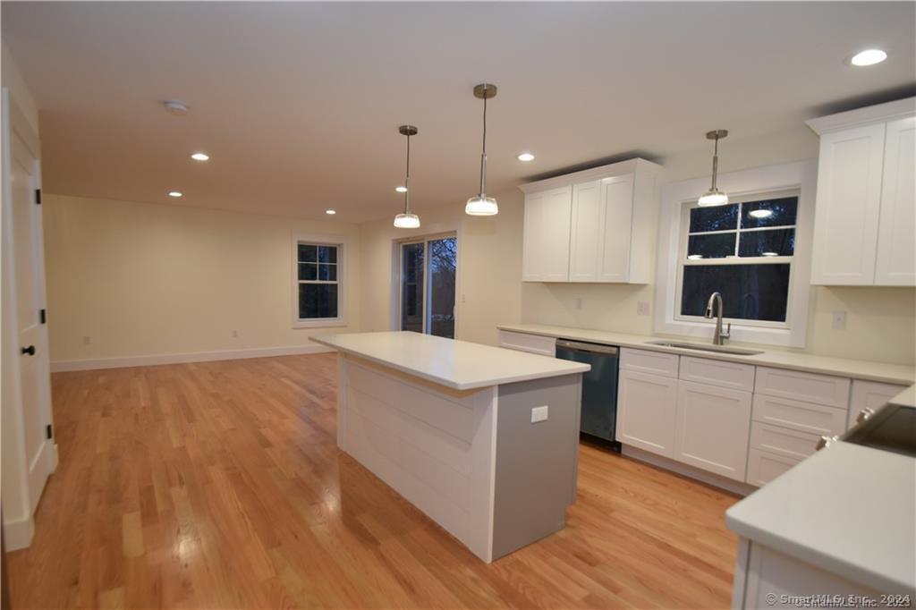 Mile Hill Road Tolland, CT 06084 - Photo 9 of 32 a open kitchen with kitchen island a stove a sink a center island and wooden floor
