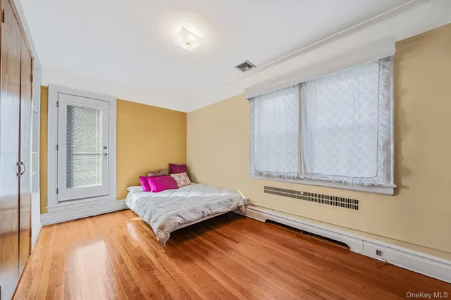 a bedroom with a bed and window