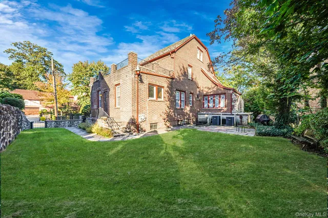 a view of a house with a yard and sitting area
