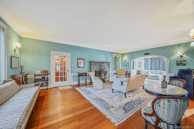 a living room with fireplace furniture and a table