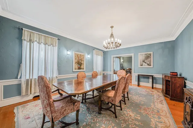 a view of a dining room with furniture and chandelier