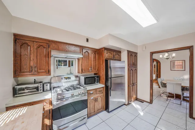 a kitchen with stainless steel appliances granite countertop a refrigerator and a stove top oven