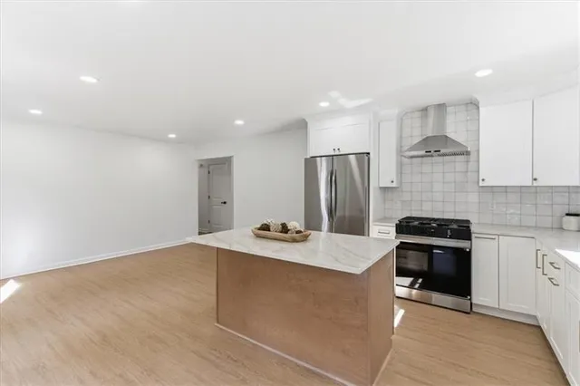 a bathroom with a shower a toilet and a window
