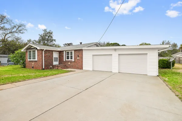 a aerial view of a house with a yard and potted plants