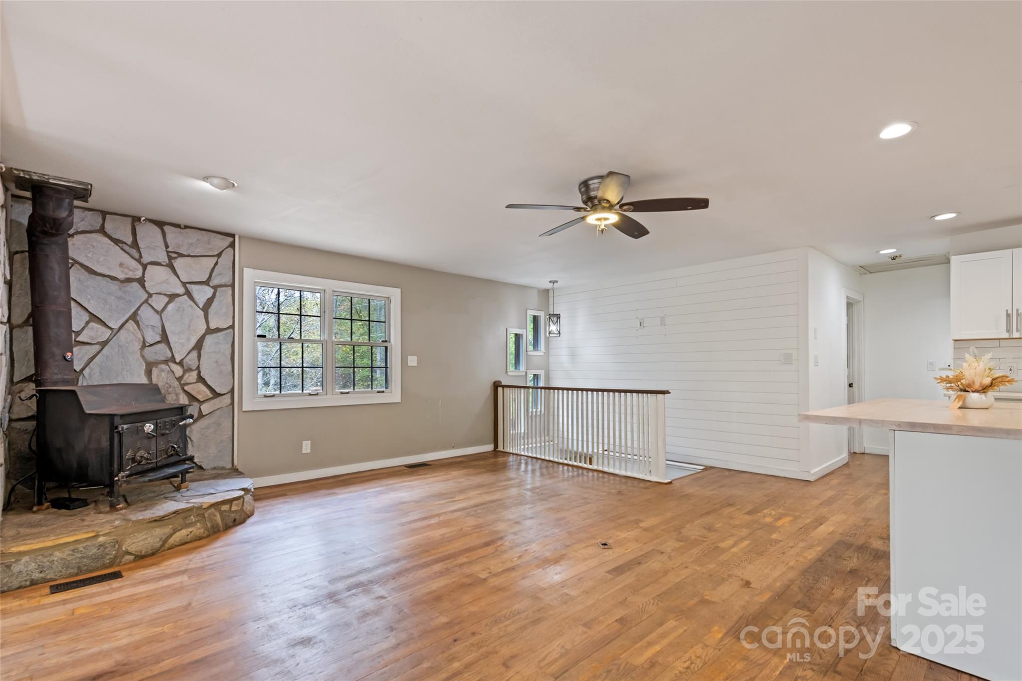940 Haynes Cove Clyde, NC 28721 - Photo 16 of 48 a view of livingroom with hardwood floor and a ceiling fan
