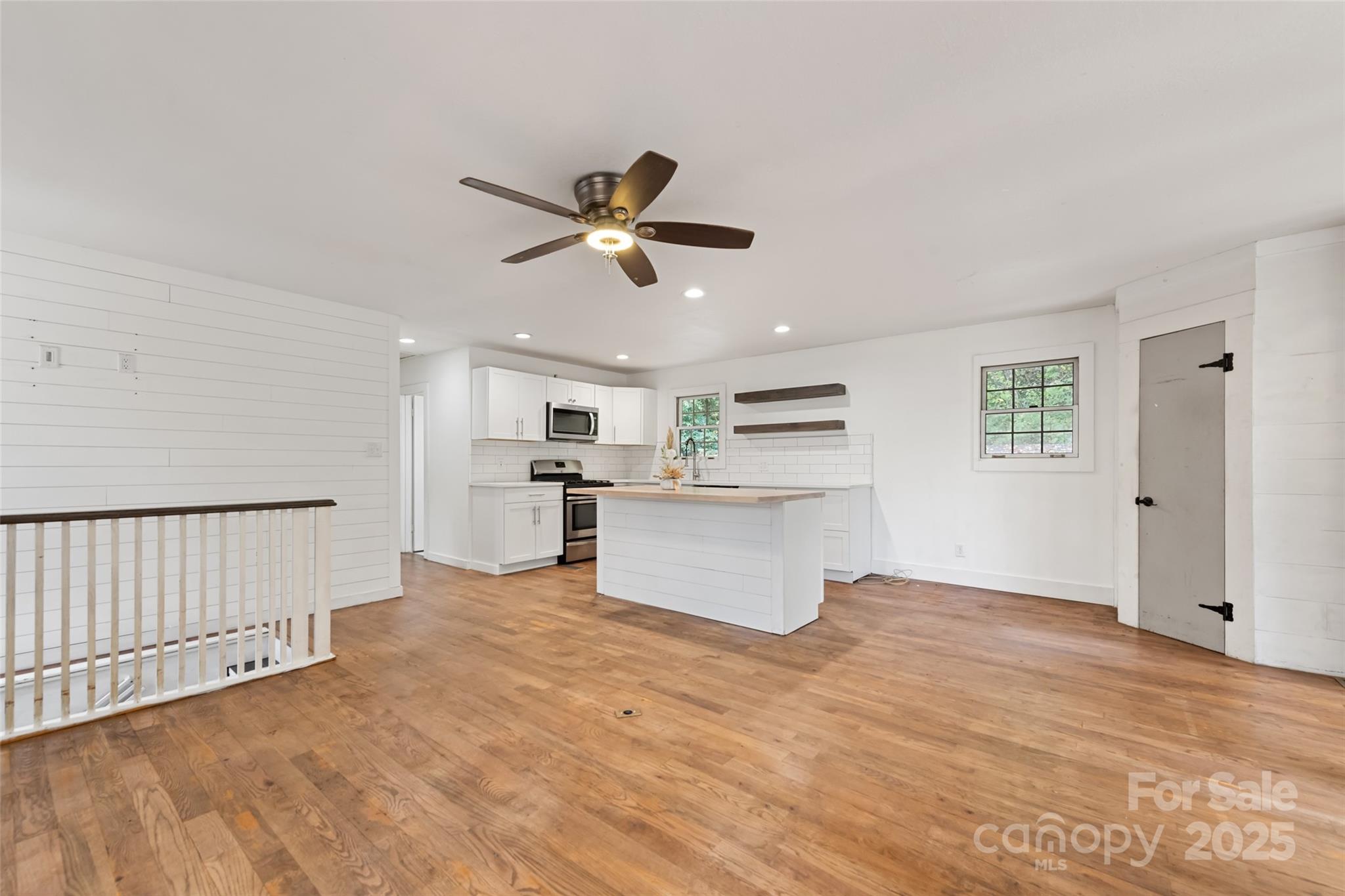 940 Haynes Cove Clyde, NC 28721 - Photo 17 of 48 a view of kitchen with wooden floor and window
